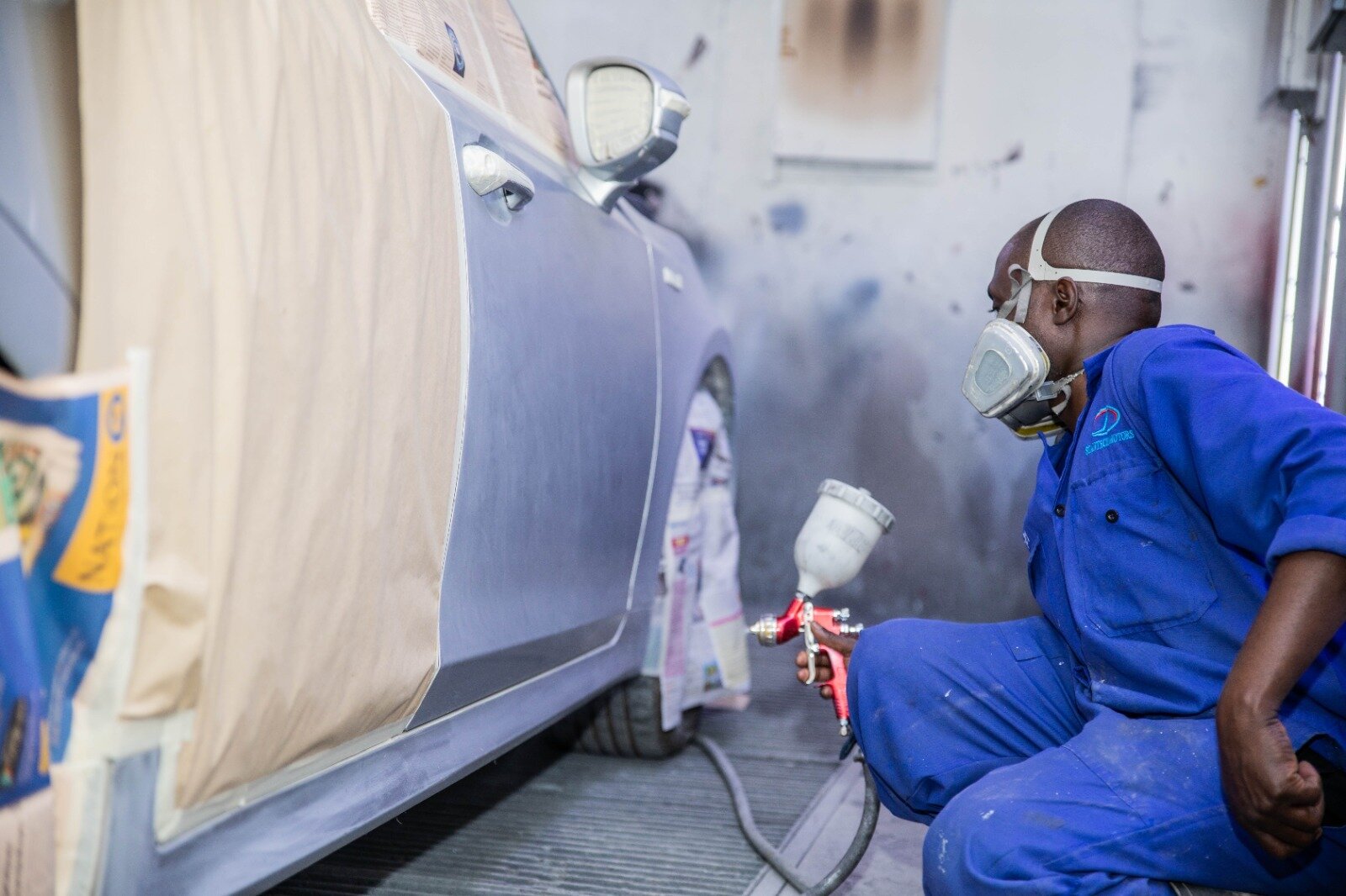 Mechanic grinding inside vehicle